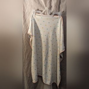 White swaddle blanket with orange, blue and yellow stars and pink border